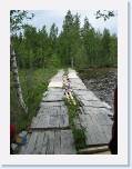 IMG_6137 * Ulrika's father is one handy man, he built the rock solid cabin and other out buildings, but his bridge left a little to be desired.  The water is only about 3 - 4 feet deep here, but crossing this bridge in a car that was loaded with about 500 lbs of alcohol was a tad scary * 899 x 1199 * (150KB)